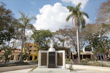 Bayamo, Cuba - January 8, 2014: Cuban people at Cespedes Park with the statue of Perucho Figueredo in front.