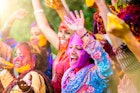 Indian women covered in colourful powder for Holi Festival in Jaipur.