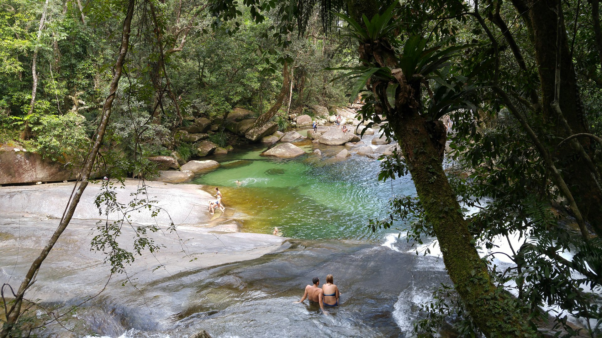 People bathing at Josephine Falls, a tiered cascade waterfall on Josephine Creek located in the Far North region of Queensland. 
