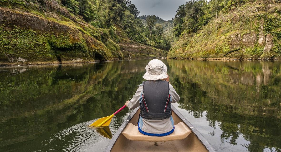 Woman canoeing on river Whanganui, North Island, New Zealand