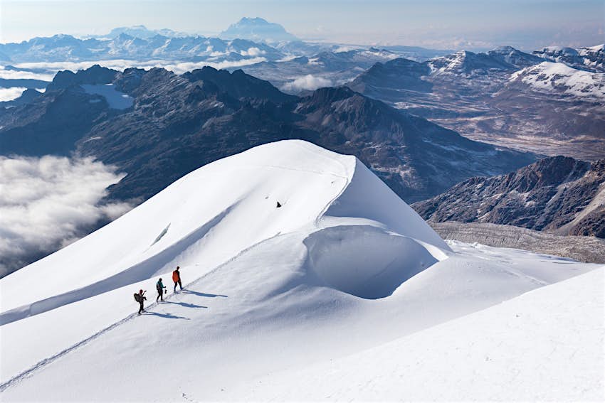 Three mountaineers on a snow ridge near Huayna Potosi 