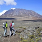 Two women overlook the Marangu Route on Mt. Kilimanjaro in Tanzania.