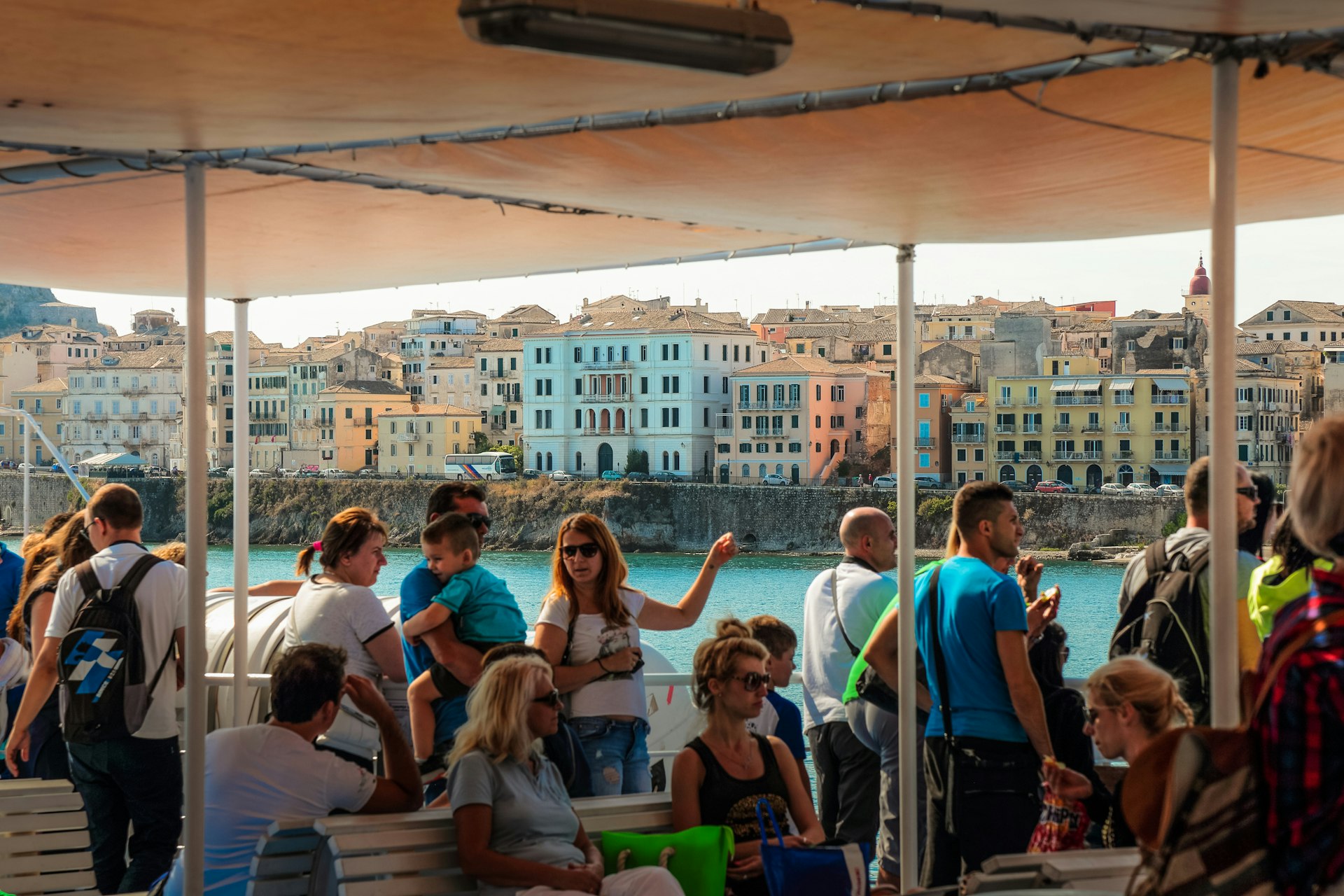 Tourists on the ferry boat arriving to Corfu, Greece.