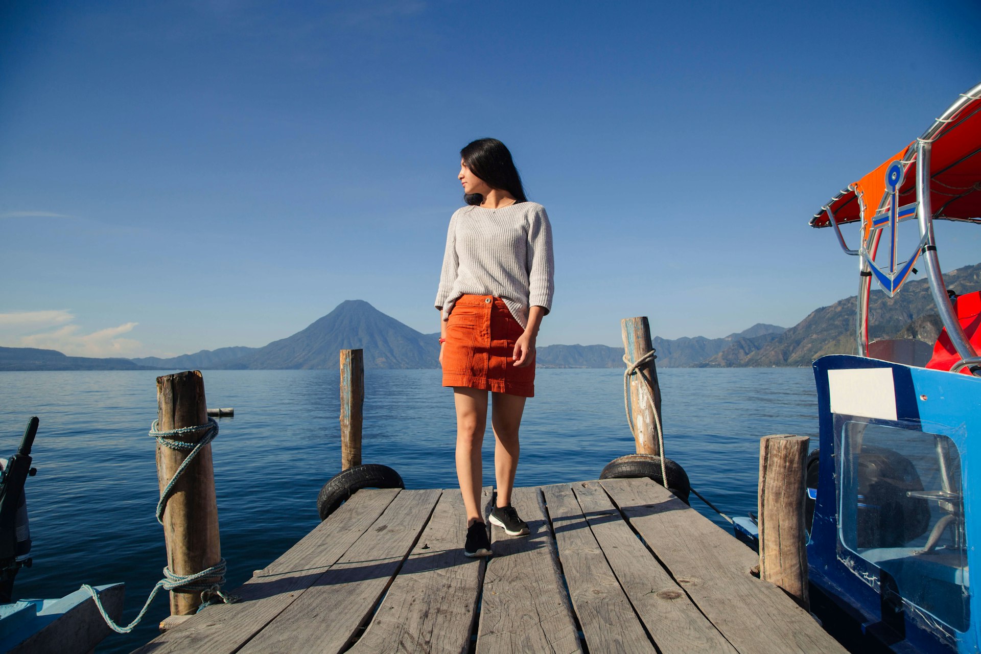 Hispanic woman on a pier beside Lake Atitlan in Guatemala