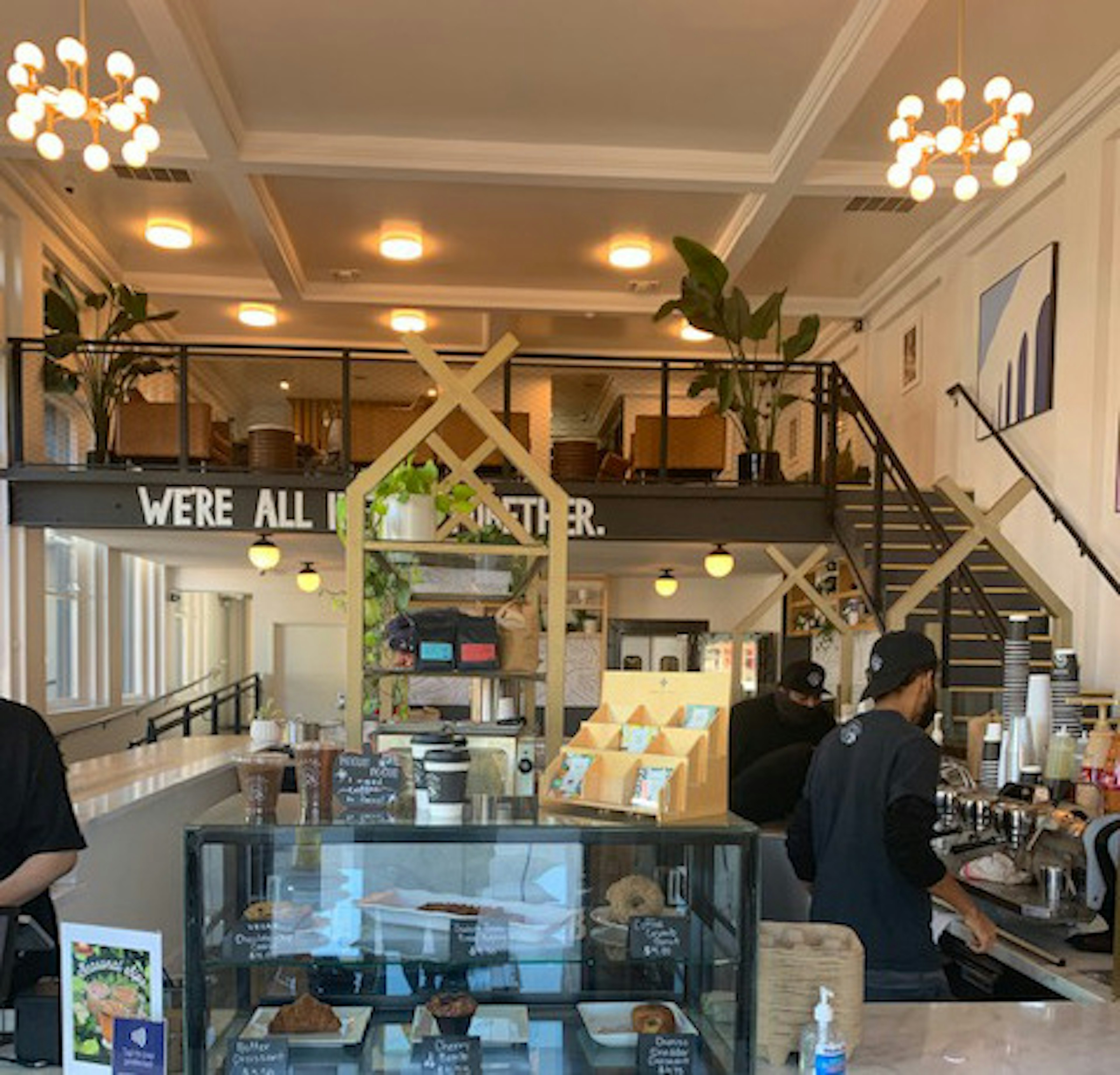 A group of people work behind the counter at Hilltop Cafe in Inglewood, LA