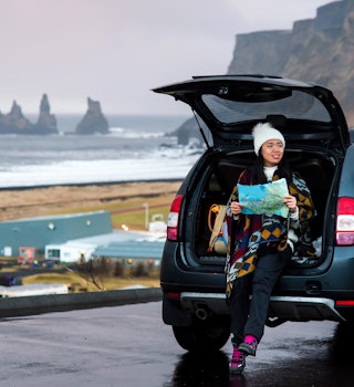Traveler with map planning Iceland trip from the car