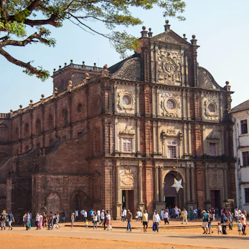 OLD GOA, INDIA - DECEMBER 27, 2018: Unidentified tourists visit the famous landmark - Basilica of Bom Jesus (Borea Jezuchi Bajilika) in Old Goa, India. Basilica is a UNESCO World Heritage Site.