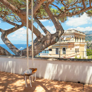 Raffaele Celantano was born in Sorrento. Over the years he has documented daily life of Sorrento locals and black and white prints 'The Italian Collection' are displayed on the second floor of the Chiostro di San Francesco. The swing used in the photograph taken by local artist Raffaele Celantano.
