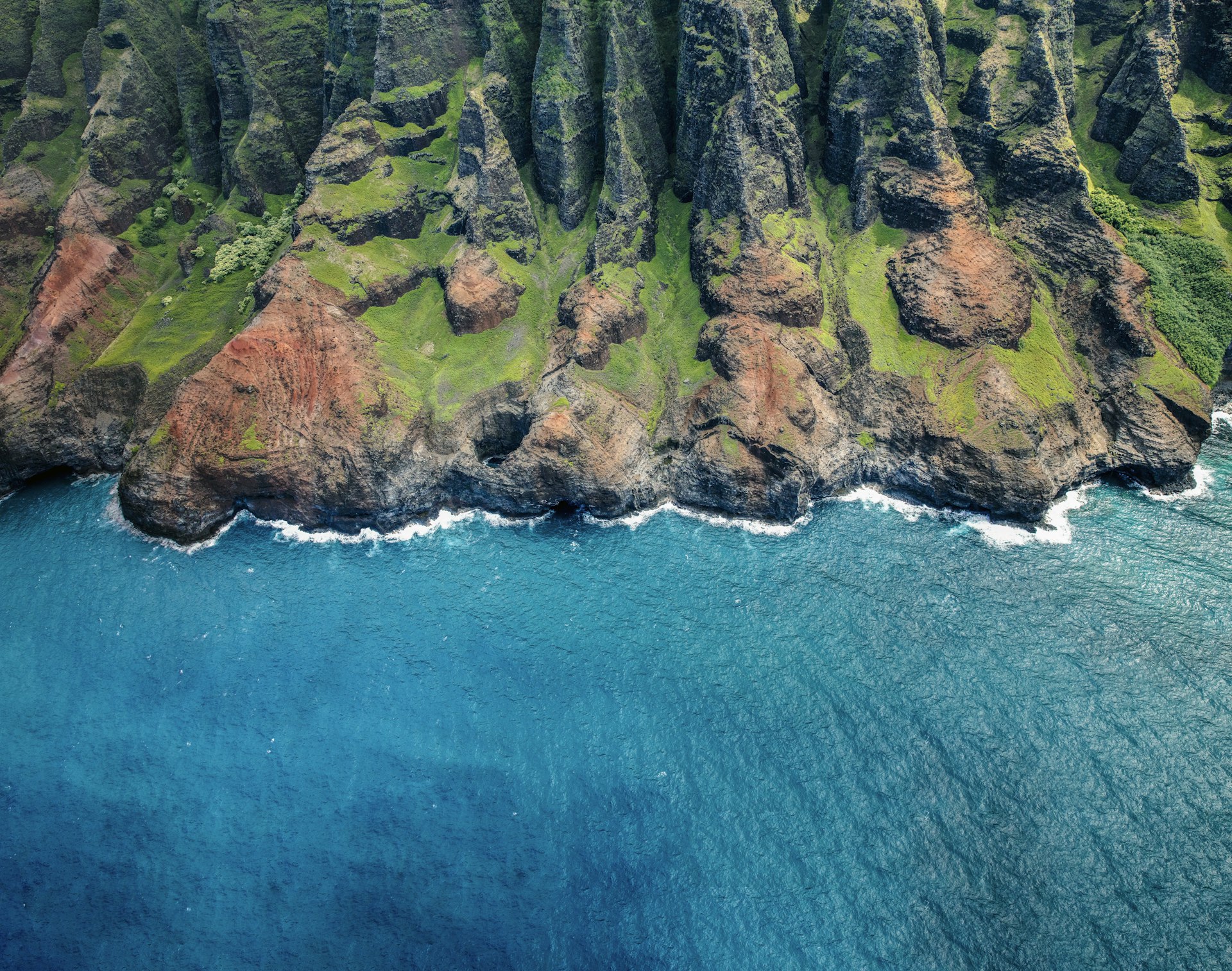 The rugged coast of Kauai as seen from a helicopter above