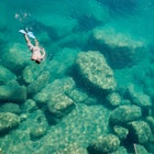 A snorkeler explores the scenic rock formations of the islands of Lake Malawi, Malawi, Africa.; Shutterstock ID 151133624; your: Claire Naylor; gl: 65050; netsuite: Online editorial; full: Malawi national parks