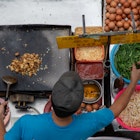 Street Food Vendor Frying Carrot Cake. Fried carrot cake is popular local food in Malaysia among Chinese in Kota Kinabalu City, Sabah, Malaysia; Shutterstock ID 1399294724; your: Claire Naylor; gl: 65050; netsuite: Onlin editorial; full: Malaysia places to go