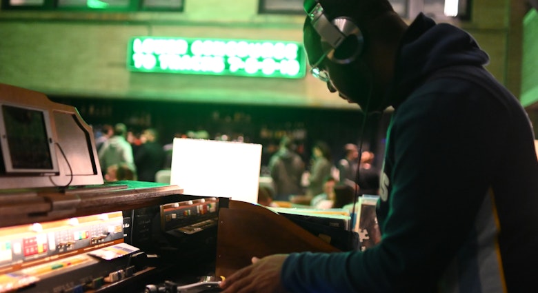 A DJ wearing headphones while scratching a record during a party at Central Station in Memphis. 