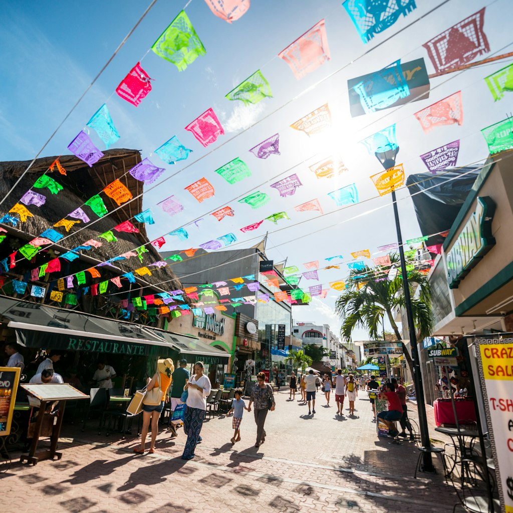Playa Del Carmen, Mexico - December 27, 2016: Tourists exploring famous shopping street in Playa Del Carmen - 5th Avenue (Quinta Avenida), full of shops and cafes.