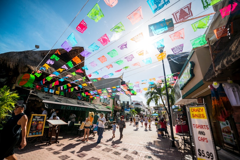 Playa Del Carmen, Mexico - December 27, 2016: Tourists exploring famous shopping street in Playa Del Carmen - 5th Avenue (Quinta Avenida), full of shops and cafes.
