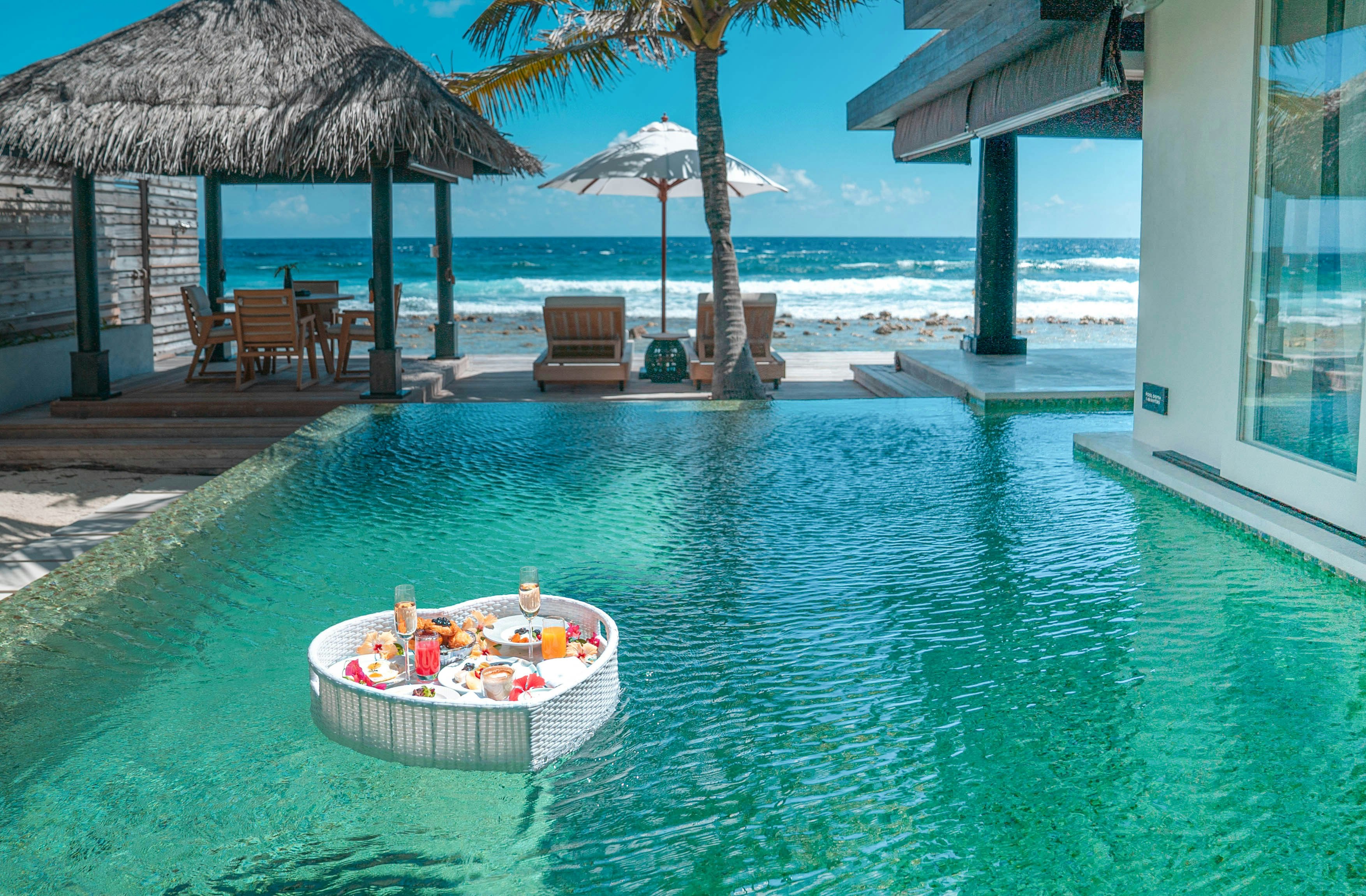 A floating Champagne breakfast in a private pool at the Naladhu Private Island resort, Maldives