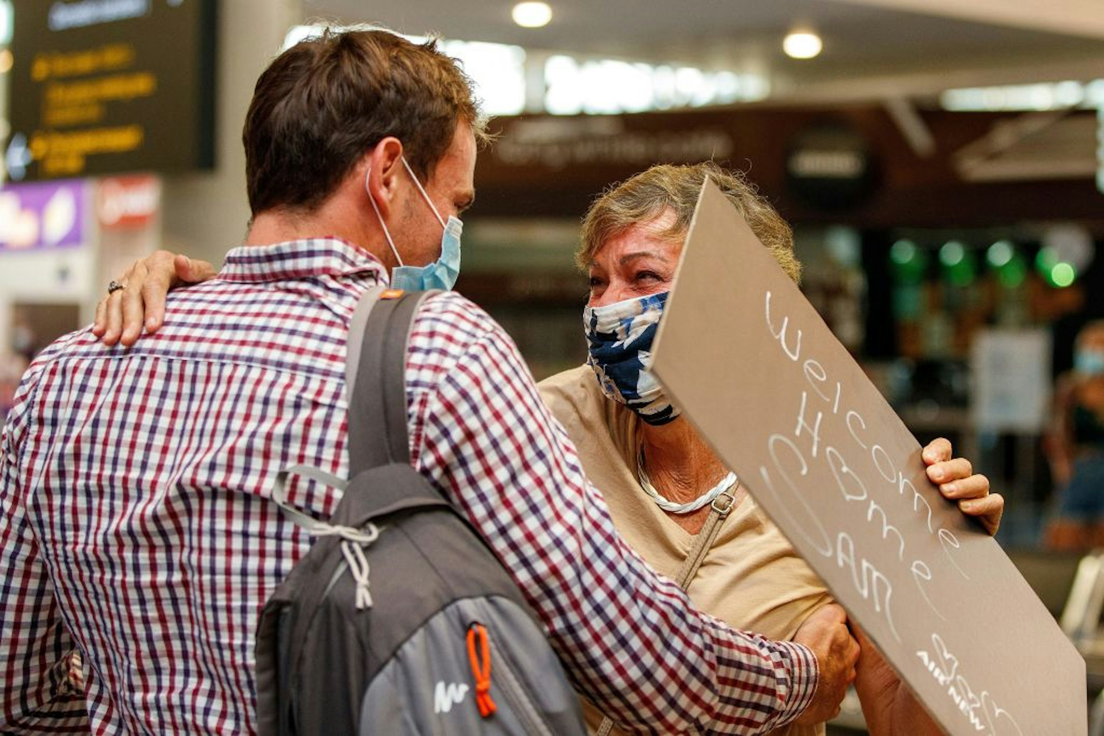 Passengers and loved ones reunite at the arrivals hall in Auckland airport