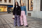 STOCKHOLM, SWEDEN - FEBRUARY 08: Linn Eklund and Fanny Ekstrand are seen wearing purple and pink Miu Miu quilted nylon pants outside Beckmans college of design show in Stockholm fashion week Autumn/Winter 2022 on February 08, 2022 in Stockholm, Sweden. (Photo by Raimonda Kulikauskiene/Getty Images)