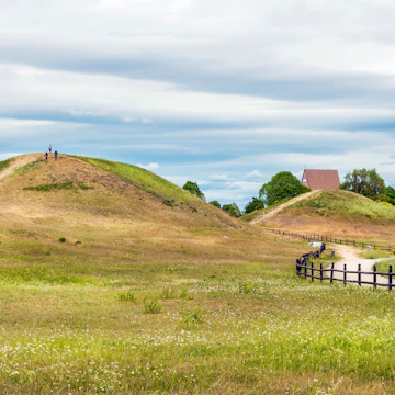 Royal Mounds - large barrows located in Gamla Uppsala village, Uppland, Sweden (70 km from Stockholm). Beautiful Viking graves covered by grass. Gamla Uppsala is area rich in archaeological remains.; Shutterstock ID 1138429115; your: Bridget Brown; gl: 65050; netsuite: Online Editorial; full: POI Image Update