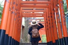 10-February-2017 Tokyo, Japan: Woman tourist is walking and sightseeing inside the Vermilion Torii Gates In Hanazono Inari Shrine, Ueno Park in Tokyo, Japan.; Shutterstock ID 692641990; your: Ben N Buckner; gl: 65050; netsuite: Online Editorial; full: Tokyo Walking