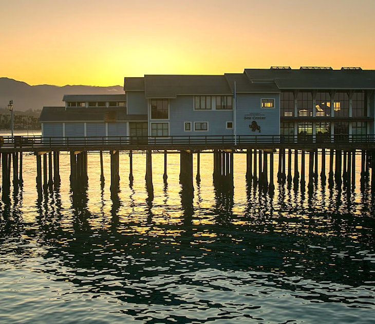 The sun rises behind the Museum of Natural History Sea Center at Stearns Wharf 