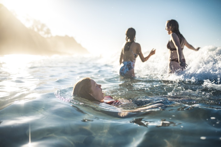 Friends swimming in the ocean in summer in Australia