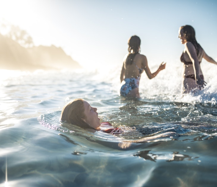 Friends swimming in the ocean in summer in Australia