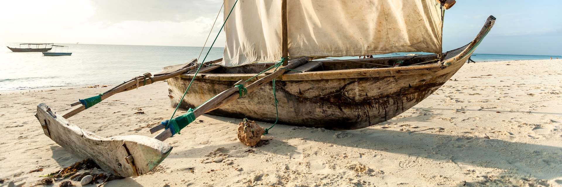 A Dhow boat on the beach. Sailing boat on the shore.