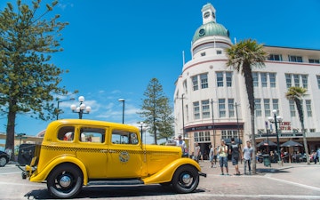 Napier, New Zealand -December-30-2017 : The classic cars tour parked in front of T&G building an iconic art deco landmark building in Napier town, New Zealand.