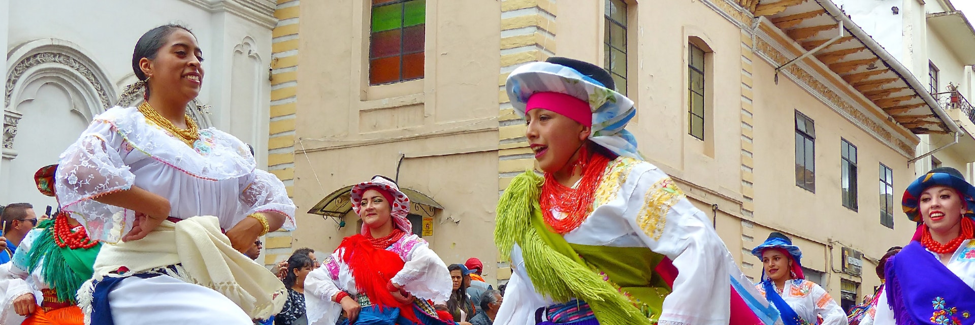 Cuenca, Ecuador - December 24,2018: Christmas parade Pase Del Niño Viajero (Traveling Child) in honor of baby Jesus. Group of folk dancers in costumes Otavalo and Cayambe people at the historical center of city