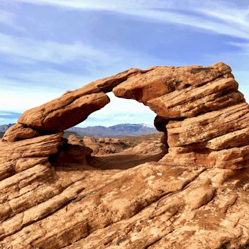 A view of red rock formations framed by the Pioneer Park Arch in St. George, Utah. Photo taken mid-morning in January during a four-day road trip from Las Vegas, Nevada to Grand Junction, Colorado.