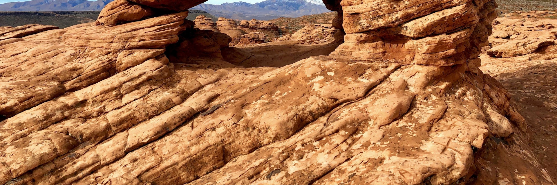 A view of red rock formations framed by the Pioneer Park Arch in St. George, Utah. Photo taken mid-morning in January during a four-day road trip from Las Vegas, Nevada to Grand Junction, Colorado.