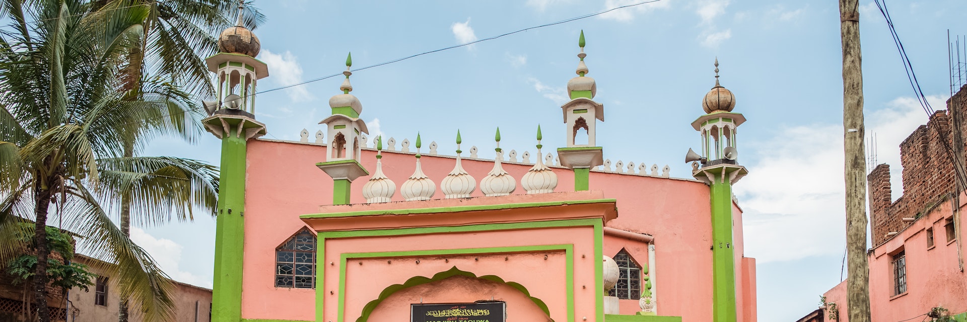 Jinja / Uganda - September 15, 2016: entrance arch to colorful pastel colored mosque
