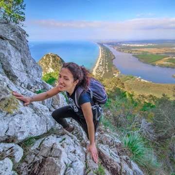 Mount Circeo, Italy - 7 November 2020 - The famous mountain on the Tirreno sea, in the province of Latina, very popular with hikers for its beautiful landscapes. Here a view from the path with girl hiker.