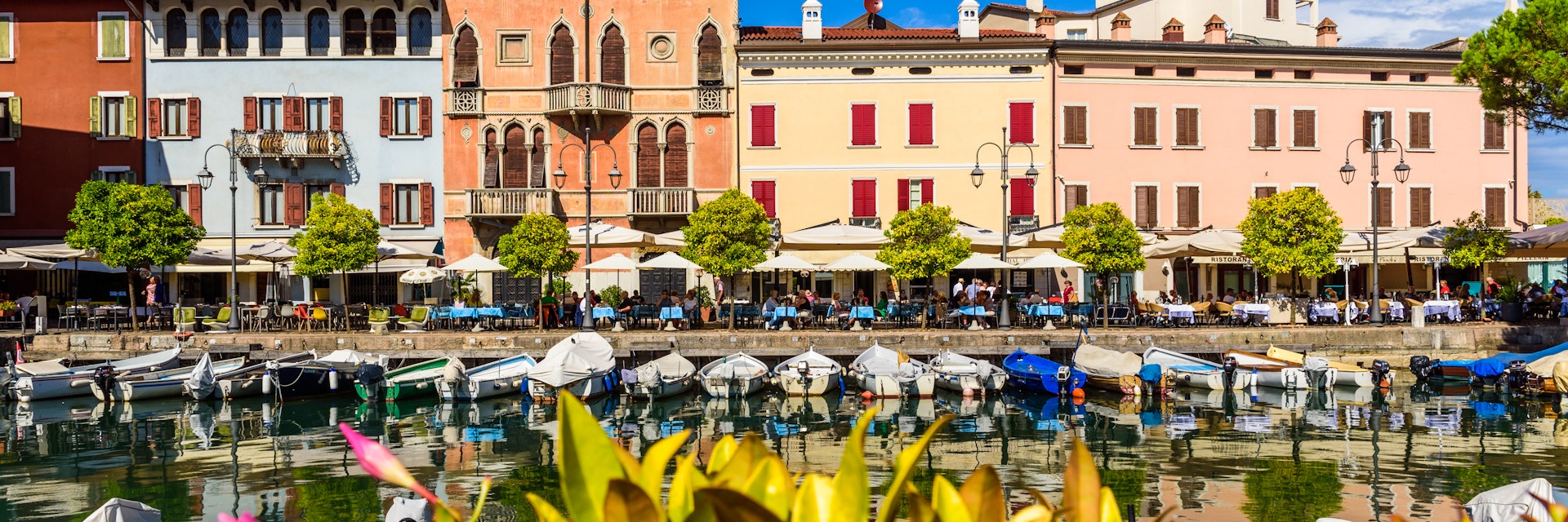 Desenzano del Garda, Italy - September 22, 2021: View of the small old port of Lake Garda a sunny day in Desenzano.