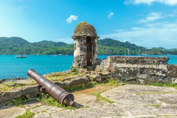 Old Spanish cannon at the fortress ruin of Santiago with a view over the Caribbean Sea in Portobelo near Colon, Panama, Central America.