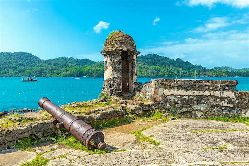 Un viejo cañón español sobre las ruinas de una fortaleza de Santiago con vistas al Mar Caribe en Portobelo, cerca de Colonia, Panamá, América Central. 