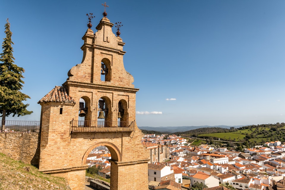 View of historic bell tower near Aracena castle and picturesque Aracena village in Huelva, Andalusia, Spain.