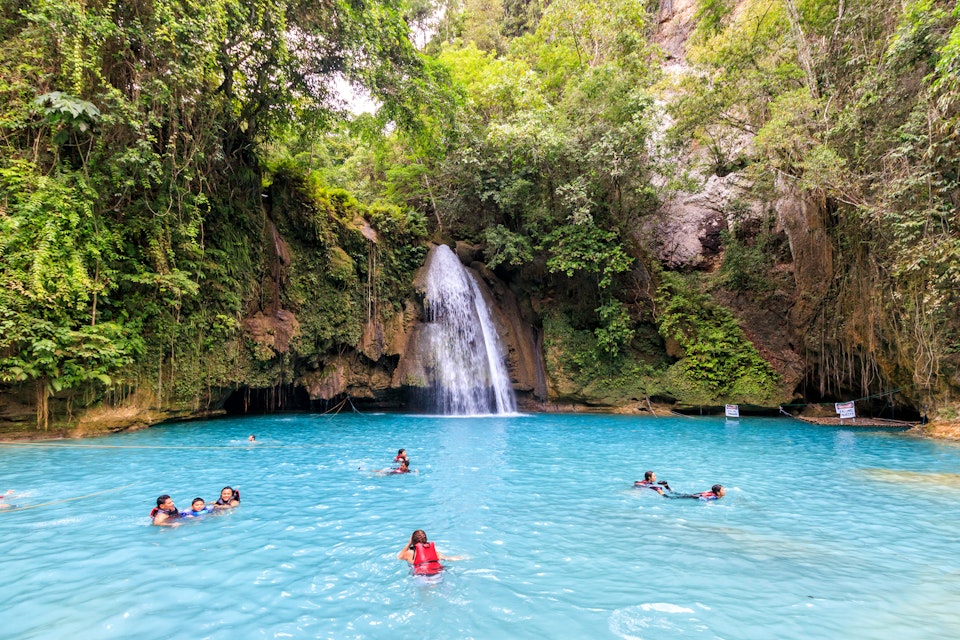 Cebu, Philippines - June 18, 2018: People swimming in Kawasan Falls in Cebu