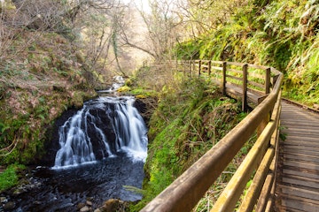 Small waterfall near a wooden path at Glenariff Country Park.