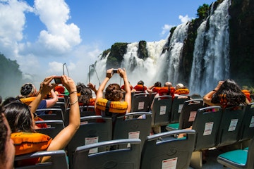 Low-angle view of Iguazu Falls, as seen from inside a tourist boat.