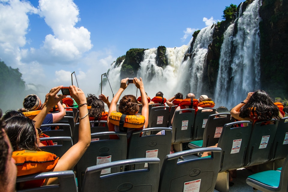Low-angle view of Iguazu Falls, as seen from inside a tourist boat.