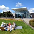 AUCKLAND,  NZL -  OCT 01 2015: Visitors having picnic at Auckland Botanic Gardens. It opened to the public in 1982 and holds more than 10,000 plants from all over the world...