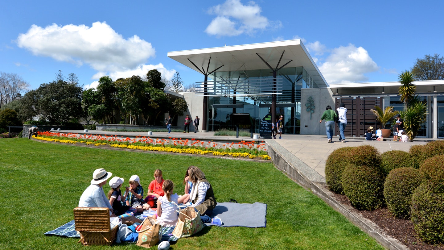 AUCKLAND,  NZL -  OCT 01 2015: Visitors having picnic at Auckland Botanic Gardens. It opened to the public in 1982 and holds more than 10,000 plants from all over the world...