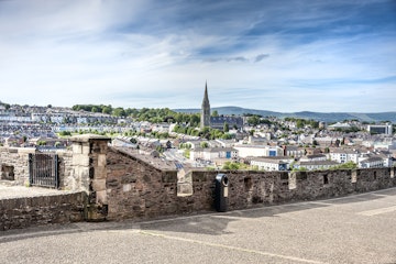 June 23, 2015: The skyline of Derry with St. Eugene's Cathedral near Free Derry Corner and the city wall.