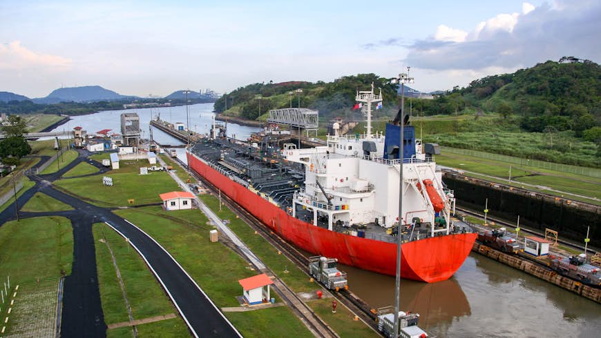 An aerial shot of a freighter passing through the Milaflores Locks of the Panama Canal
