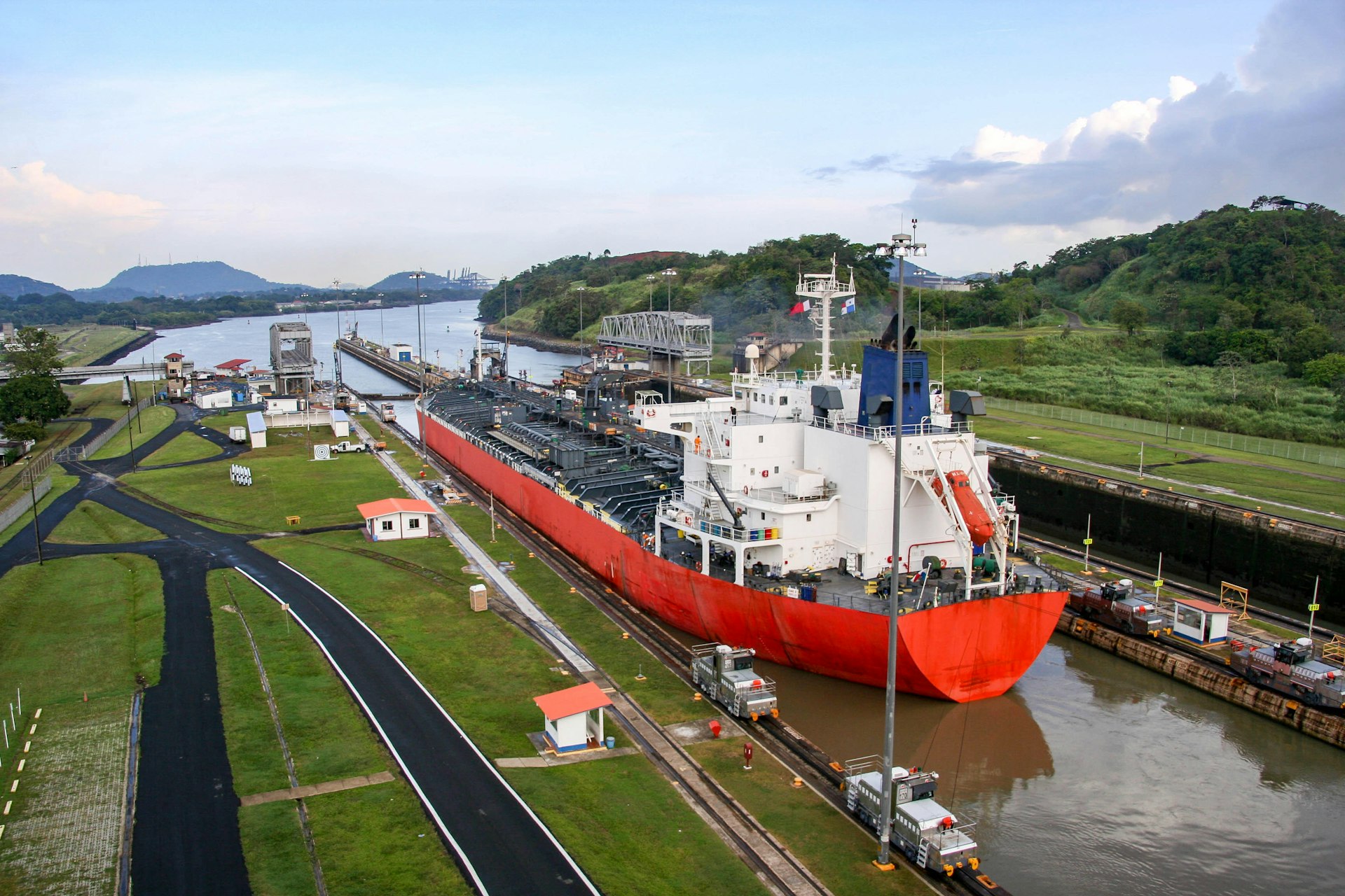 An aerial shot of a freighter passing through the Milaflores Locks of the Panama Canal