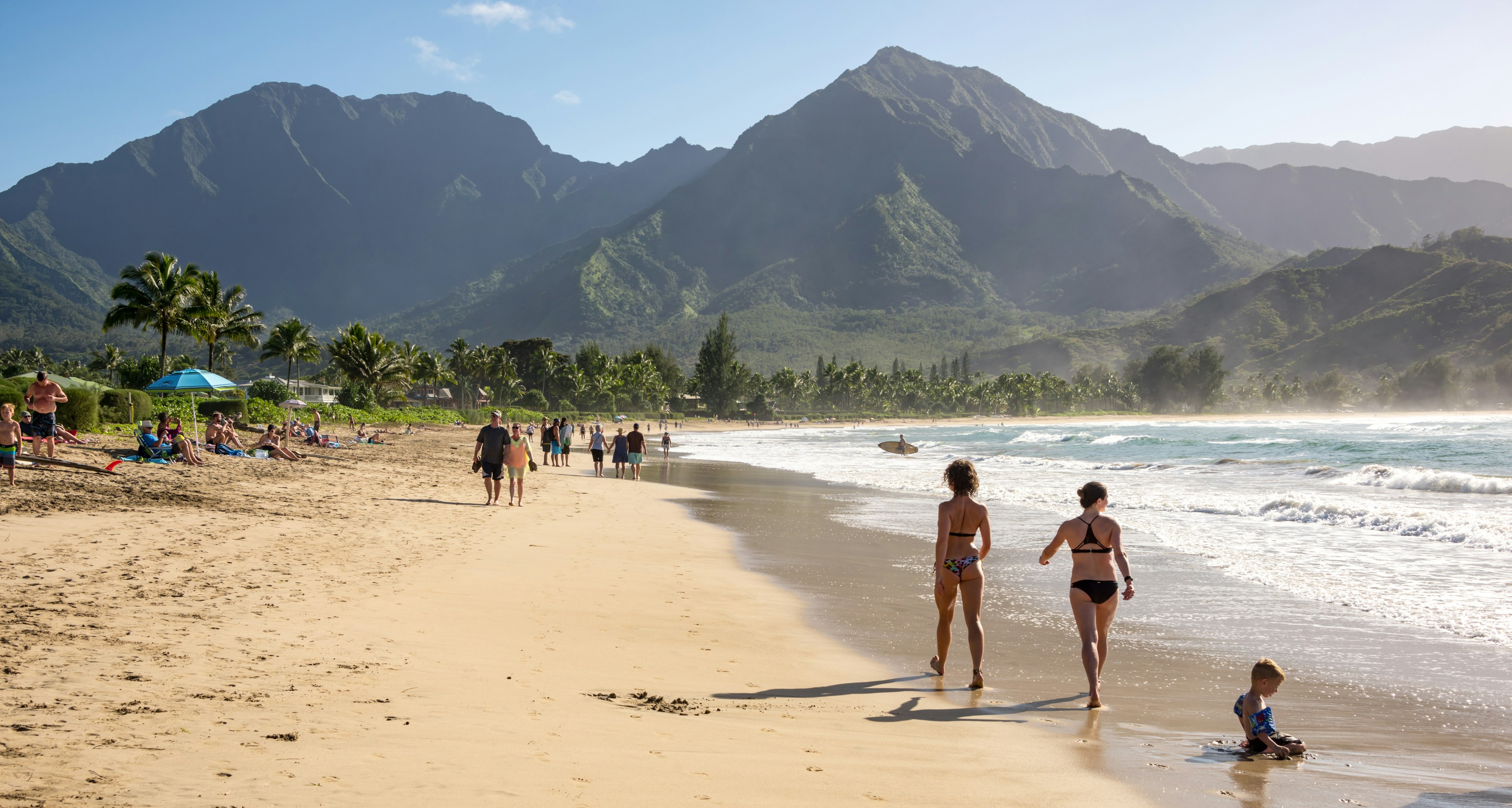 People enjoying the sun & views on the beach at Hanalei Bay