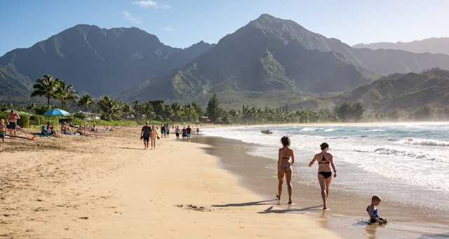 People enjoying the sun & views on the beach at Hanalei Bay