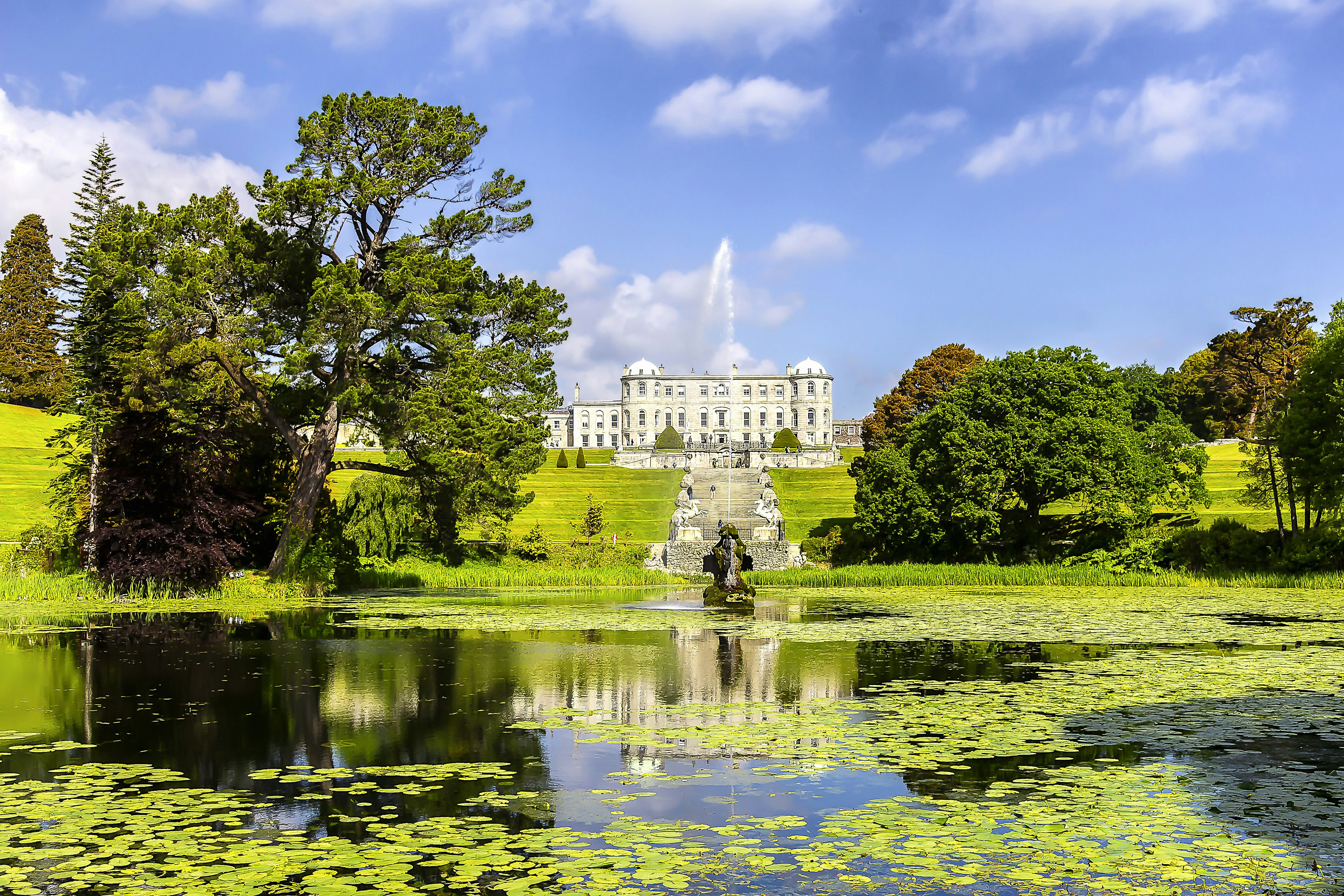 A stately home set in landscaped gardens with water features