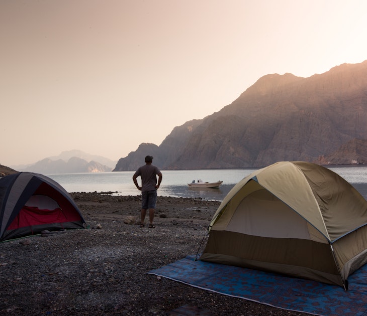Enjoying the early morning sunrise at a camping trip to Kassab, Musandam, Oman.; Shutterstock ID 1122297419; your: Brian Healy; gl: 65050; netsuite: Lonely Planet Core Demand; full: Oman on a budget